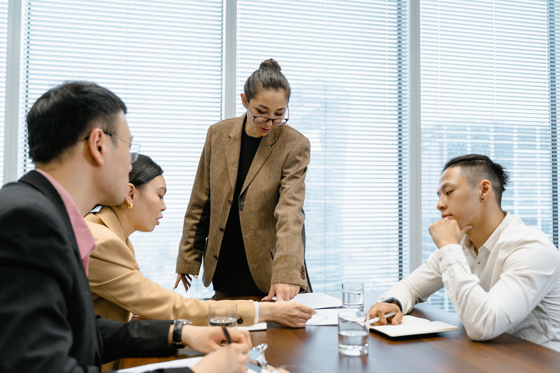 People discussing documents around a meeting table
